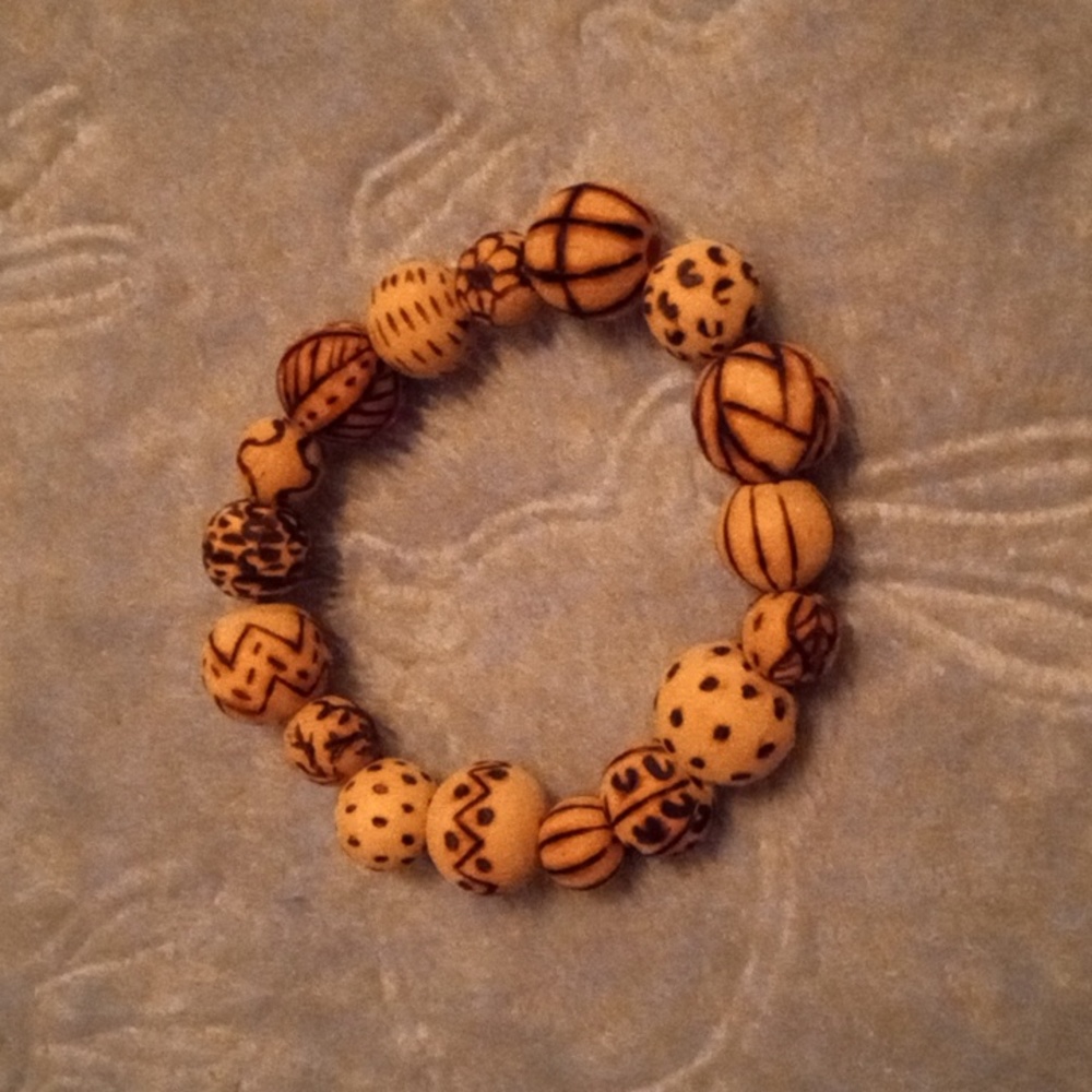 Handmade natural wood beaded bracelet with abstract wood burned design
